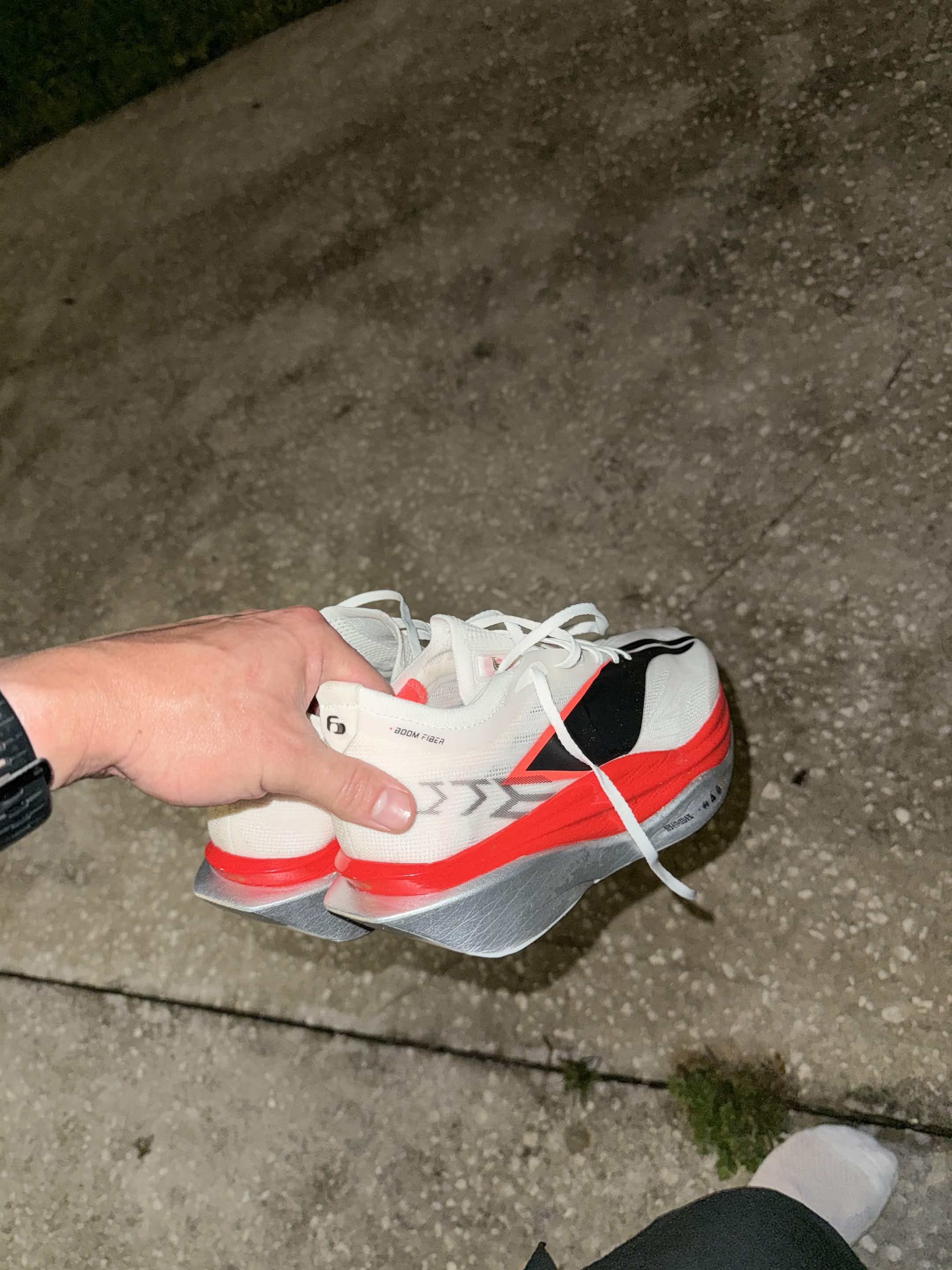 Holding the Li-Ning shoes up for a closer look after the run.