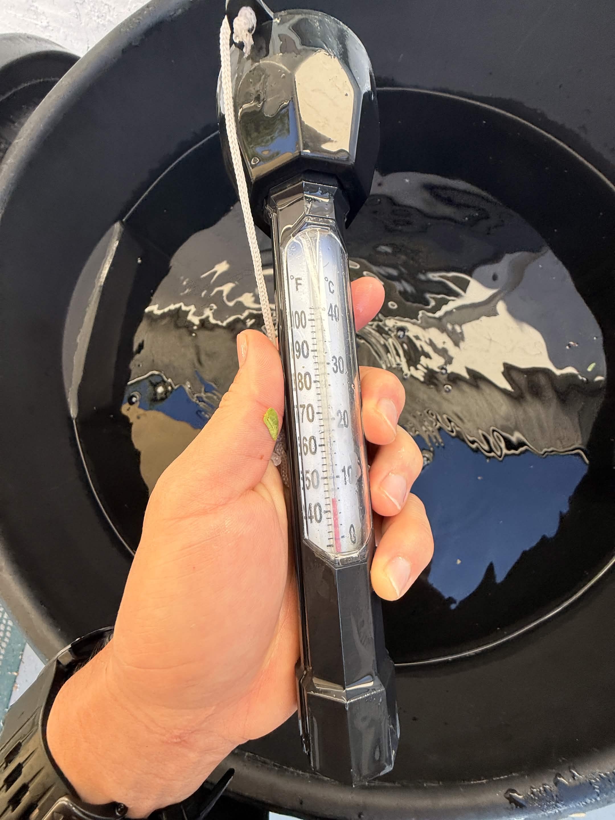 Thermometer in the cold plunge water — reading right around 40°F.