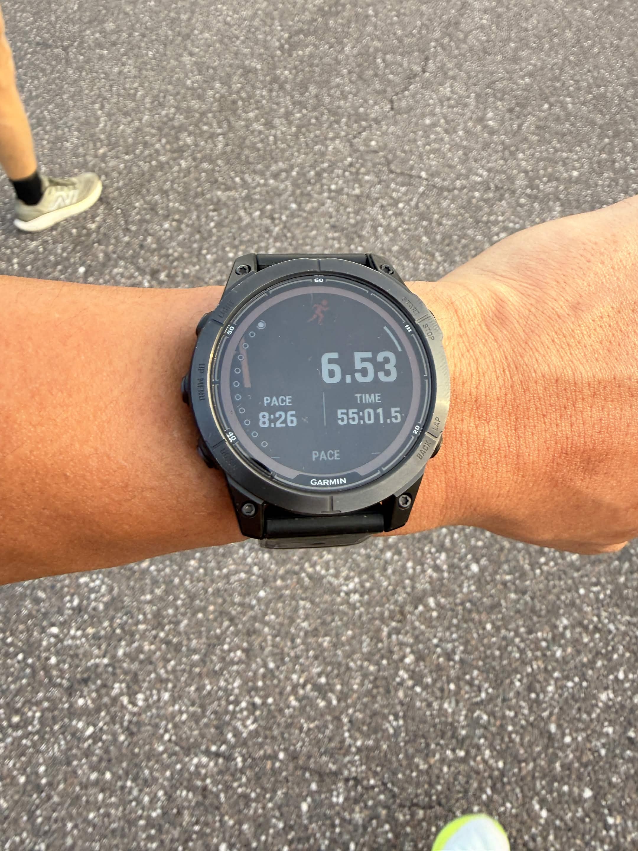 Garmin Fenix 7 Pro on my wrist: 6.53 mi, 8:26 pace, 55:01.5. Brian's New Balance in the corner.