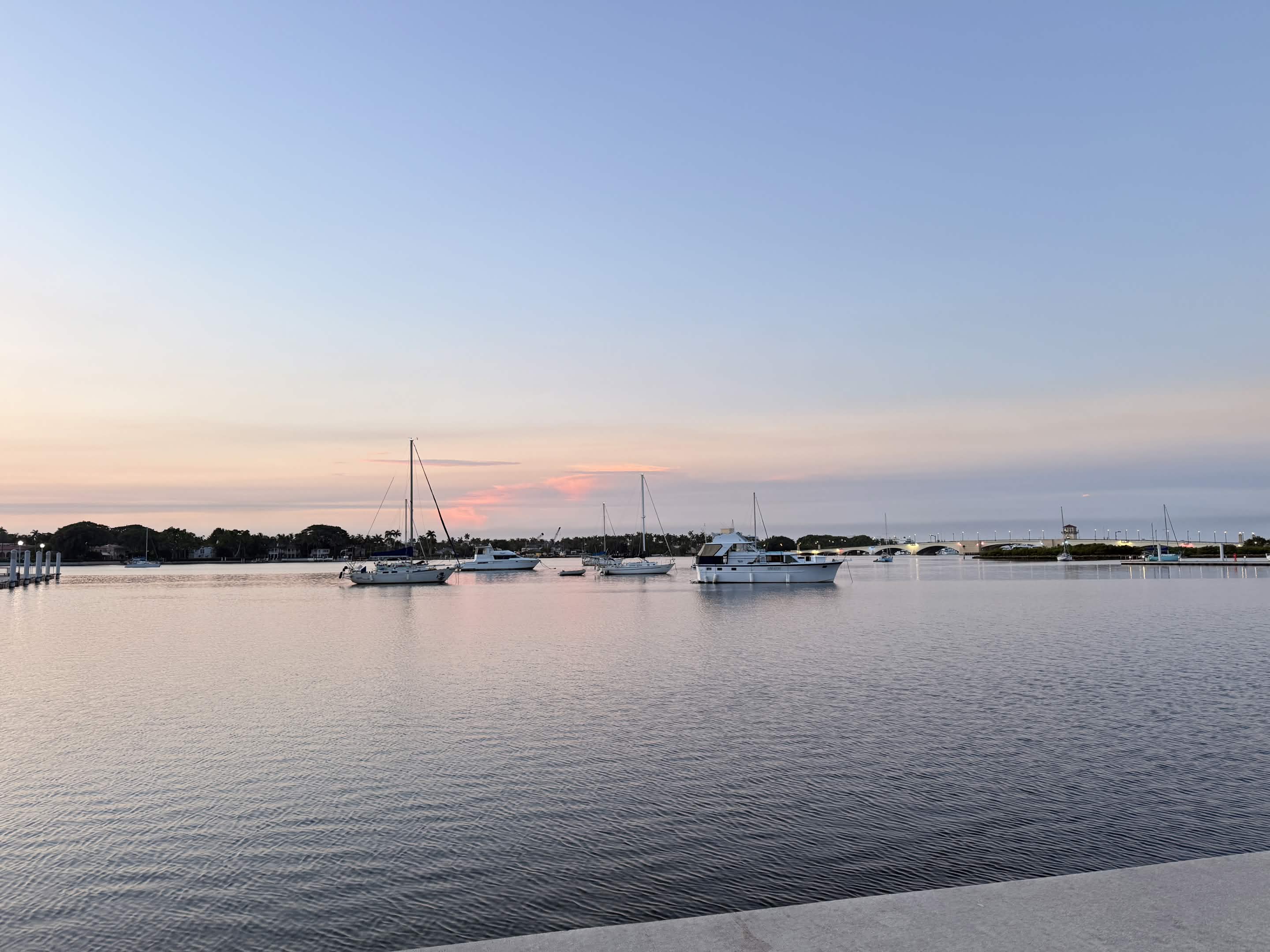 Sailboats on still water at sunrise, West Palm Beach marina.