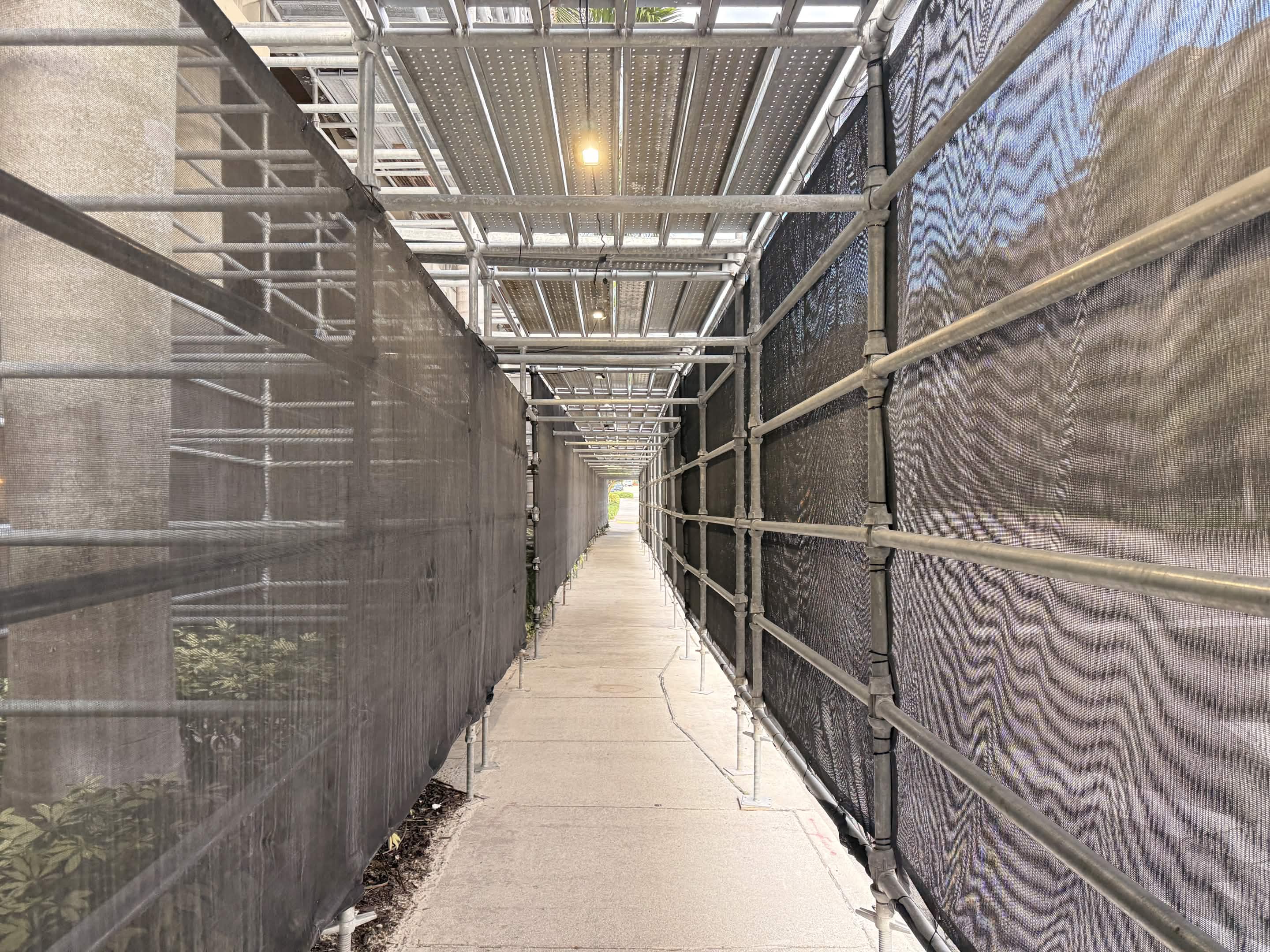 Construction tunnel mid-run — scaffolding and mesh, very different from the oceanfront.